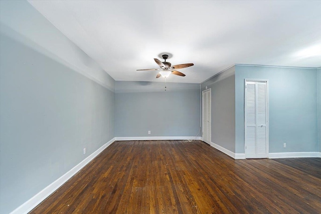 empty room featuring ceiling fan and dark hardwood / wood-style flooring