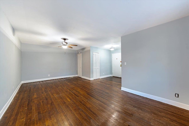 empty room featuring dark wood-type flooring and ceiling fan