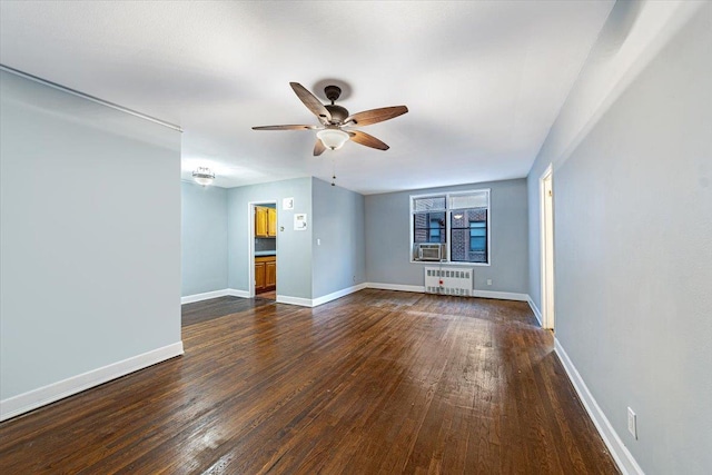 unfurnished room with ceiling fan, dark wood-type flooring, and radiator