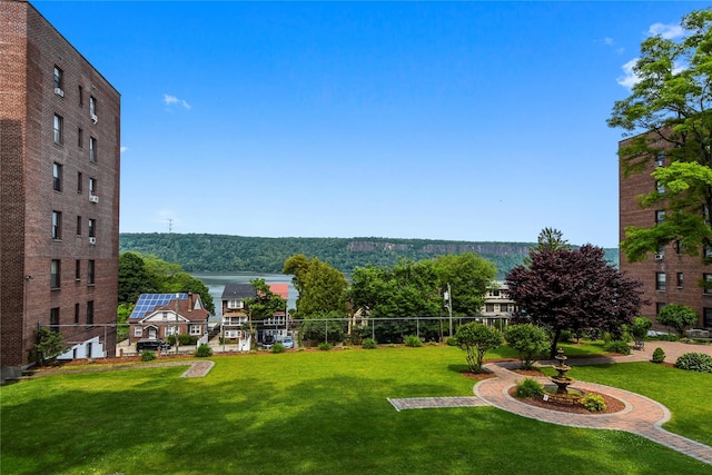 view of property's community featuring a yard