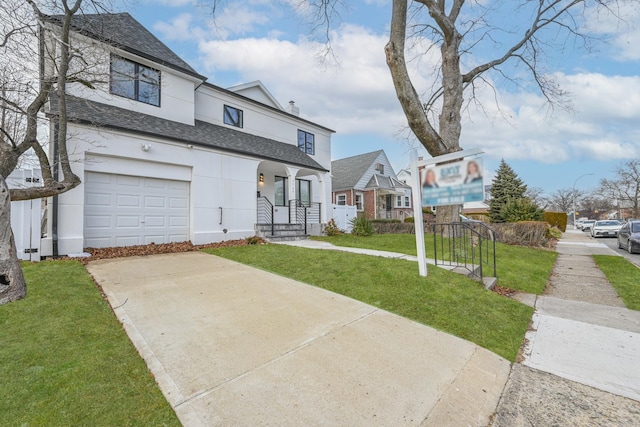 front facade with a garage and a front lawn