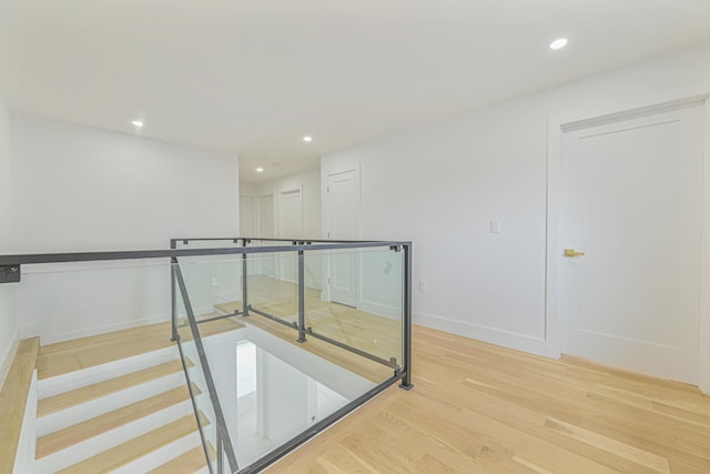 stairs with hardwood / wood-style floors