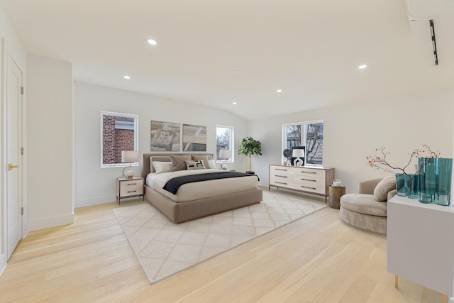 bedroom featuring vaulted ceiling and light hardwood / wood-style flooring