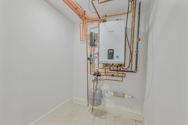 utility room with tankless water heater