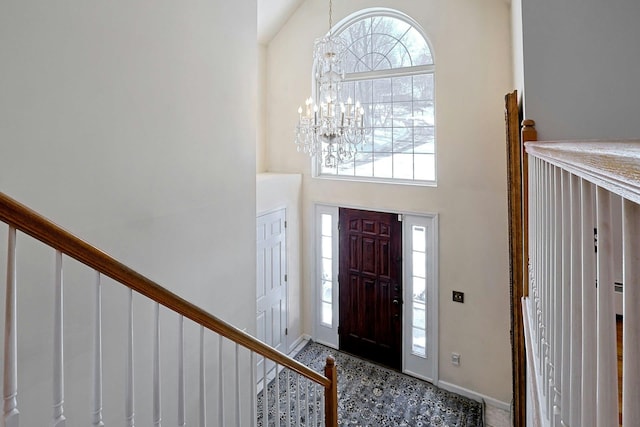 entrance foyer with a towering ceiling and a notable chandelier