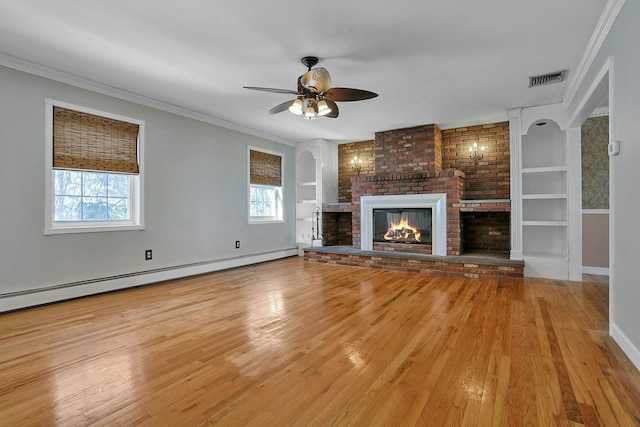 unfurnished living room with built in features, a baseboard radiator, a brick fireplace, and ornamental molding