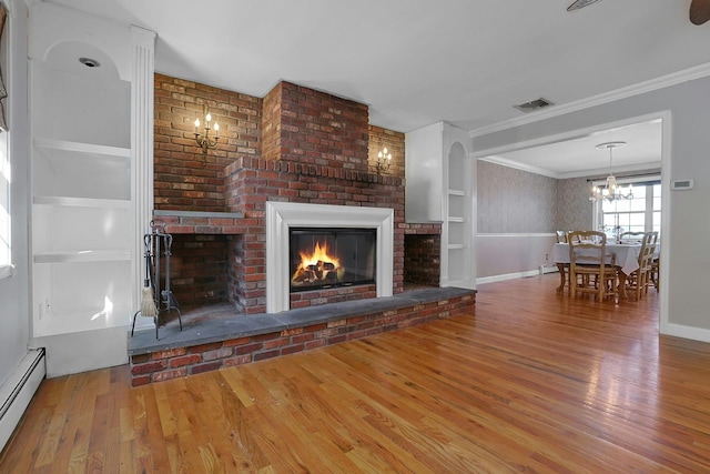 unfurnished living room featuring a fireplace, hardwood / wood-style flooring, baseboard heating, built in shelves, and ornamental molding