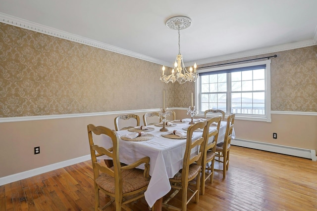 dining area featuring light wood-type flooring, crown molding, and a baseboard radiator