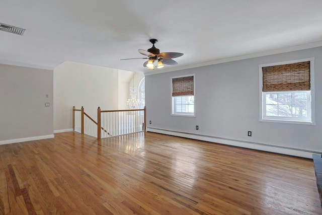 unfurnished room with a baseboard radiator, hardwood / wood-style floors, plenty of natural light, and ornamental molding