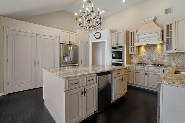 kitchen with premium range hood, a center island, decorative backsplash, and stainless steel appliances