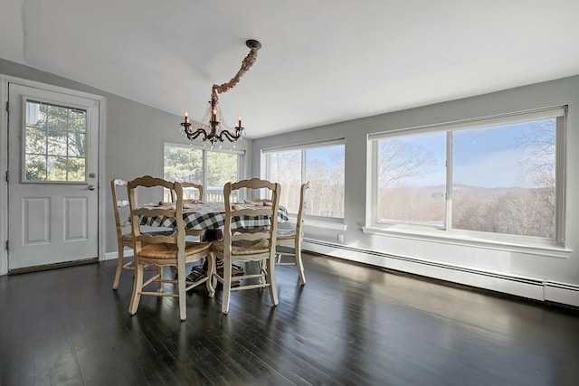 dining room featuring a baseboard radiator, a mountain view, an inviting chandelier, dark wood-type flooring, and vaulted ceiling