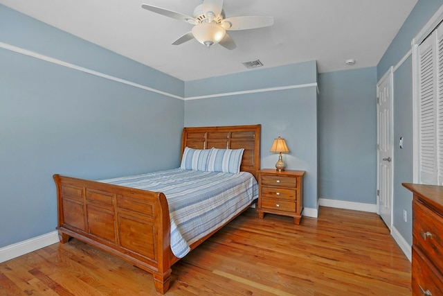 bedroom featuring ceiling fan, a closet, and light wood-type flooring