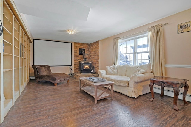 living room featuring a wood stove, baseboard heating, and dark hardwood / wood-style flooring