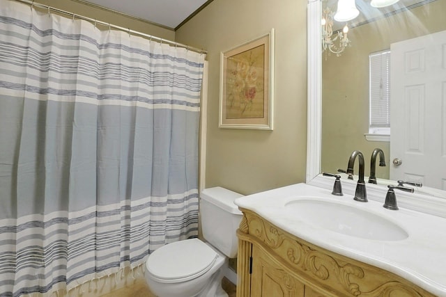 bathroom featuring ornamental molding, toilet, vaulted ceiling, and vanity