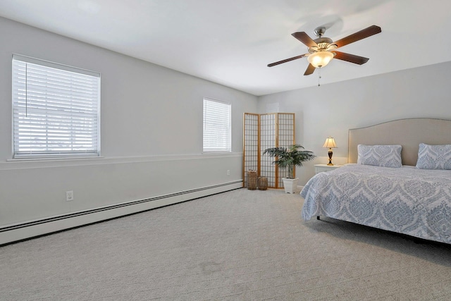 carpeted bedroom with ceiling fan and baseboard heating