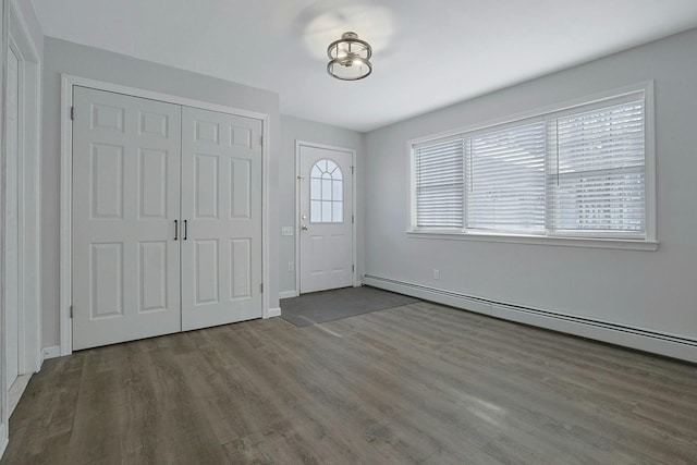 entryway with hardwood / wood-style floors and a baseboard heating unit