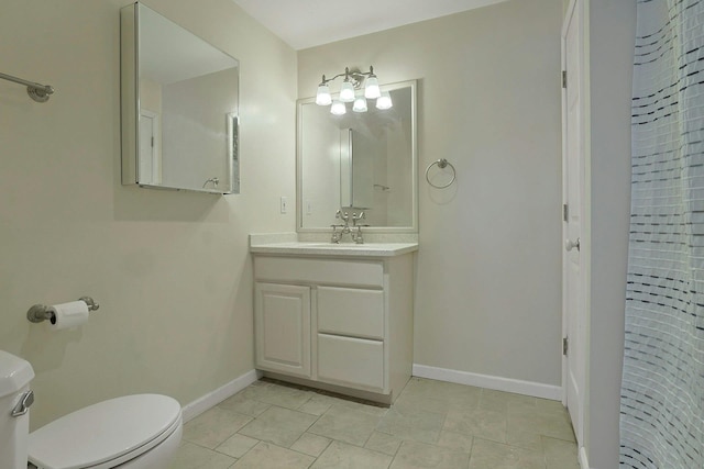 bathroom featuring toilet and vanity