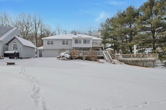 snow covered property featuring a deck