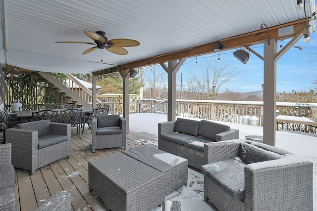 snow covered deck with ceiling fan and an outdoor hangout area