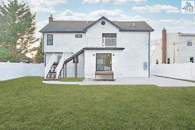 rear view of property with a lawn and a balcony