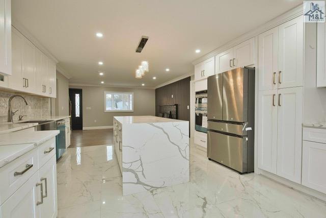 kitchen featuring white cabinets, stainless steel appliances, and sink