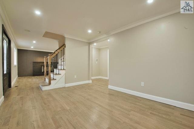 interior space featuring light wood-type flooring and ornamental molding