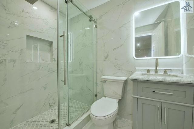 bathroom with vanity, toilet, and a shower with shower door