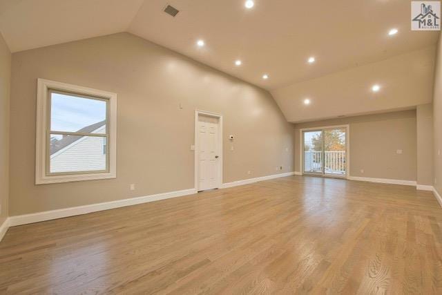 unfurnished living room featuring light hardwood / wood-style flooring and vaulted ceiling