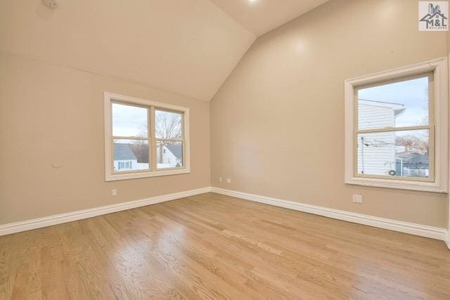 additional living space featuring light hardwood / wood-style floors and lofted ceiling