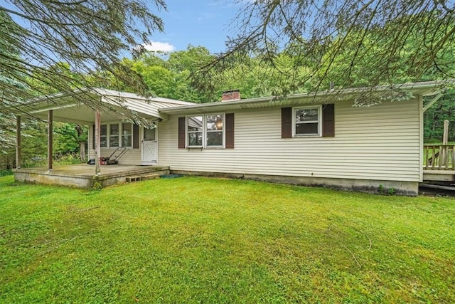 back of house with a porch and a lawn