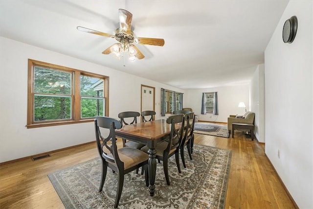 dining space featuring ceiling fan and light wood-type flooring