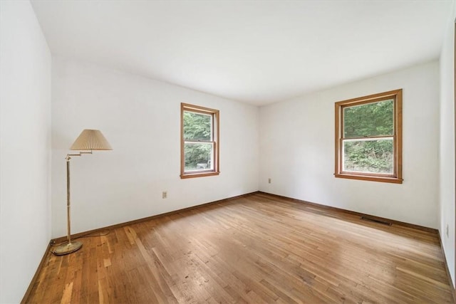 spare room featuring light wood-type flooring