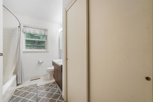 full bathroom featuring tile patterned floors, vanity, toilet, and shower / bath combo with shower curtain