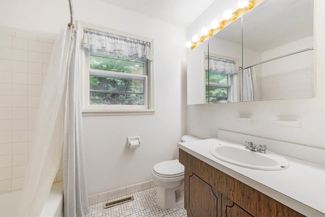 full bathroom featuring tile patterned floors, vanity, toilet, and a wealth of natural light