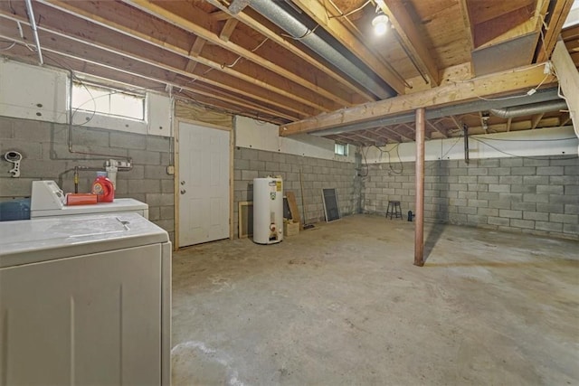 basement featuring washer and clothes dryer and water heater