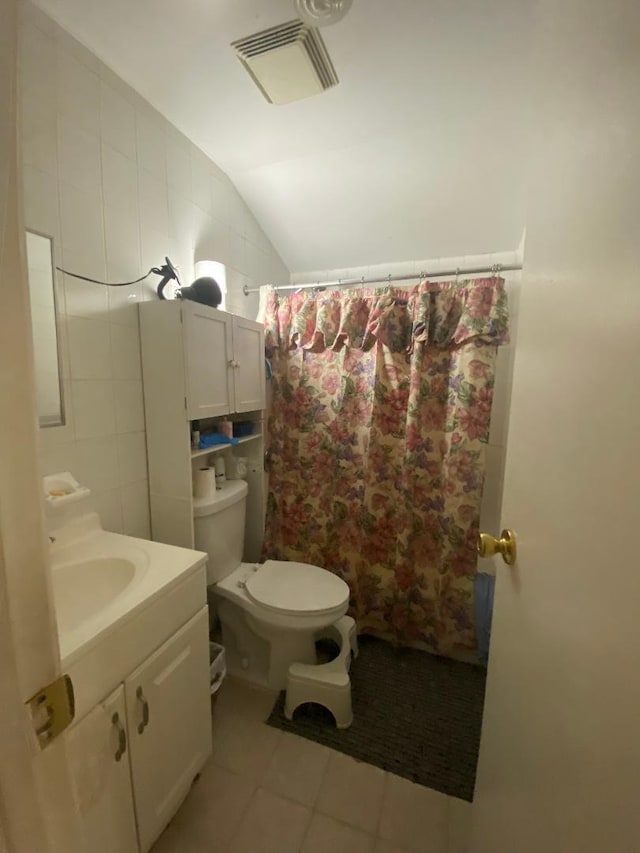 bathroom with vanity, lofted ceiling, toilet, tile walls, and curtained shower