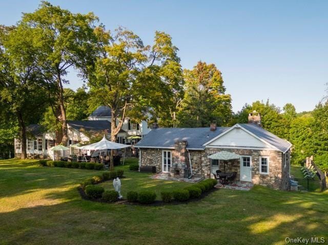 back of house with a lawn