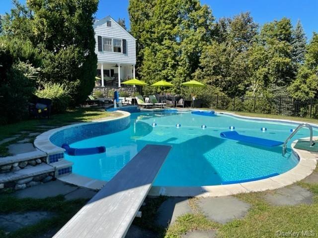 view of pool with a diving board