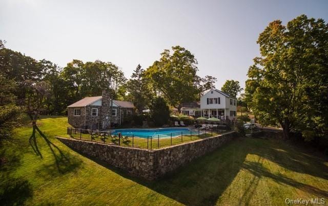 view of swimming pool featuring a lawn