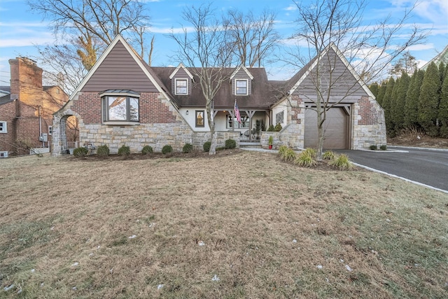 view of front of home featuring a garage and a front lawn