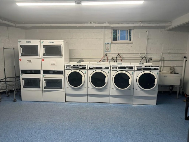 2295 Palmer Ave Unit 1P, New Rochelle, NY 10801 - communal laundry room with stacked washer and clothes dryer, washing machine and clothes dryer, and concrete block wall