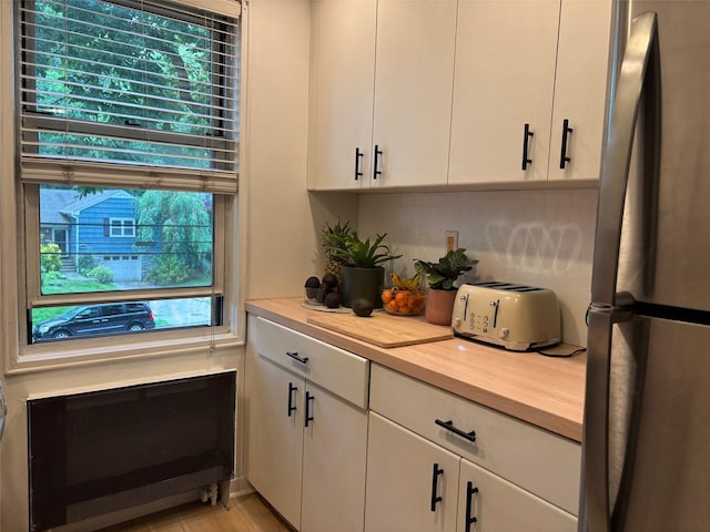 2295 Palmer Ave Unit 1P, New Rochelle, NY 10801 - kitchen with freestanding refrigerator, light countertops, and white cabinetry