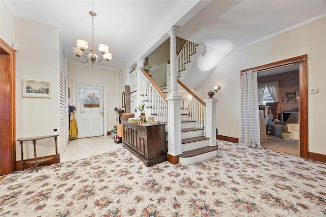 foyer with a chandelier and ornamental molding