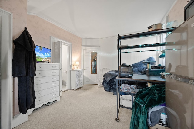 carpeted bedroom featuring ornamental molding and stainless steel refrigerator