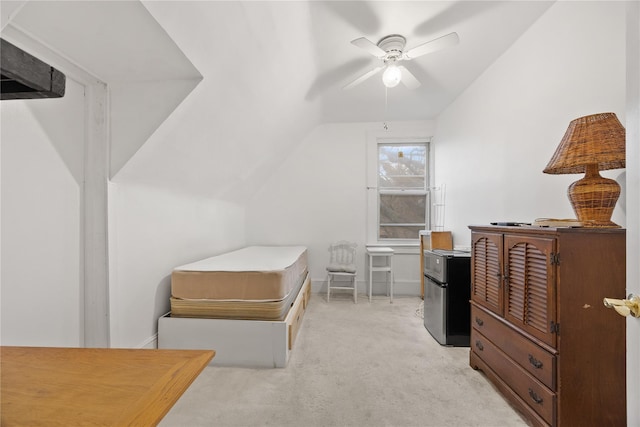 bedroom featuring light carpet, stainless steel fridge, ceiling fan, and lofted ceiling