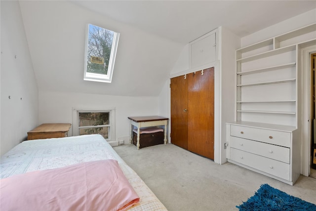 bedroom with light colored carpet and lofted ceiling with skylight