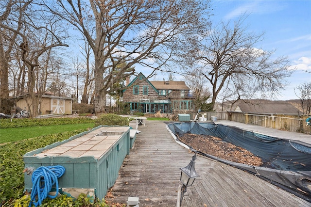 back of property with a covered pool and central AC