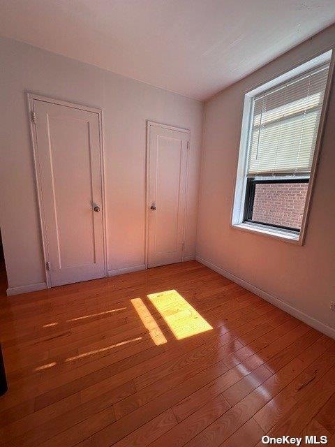 unfurnished bedroom with light wood-type flooring