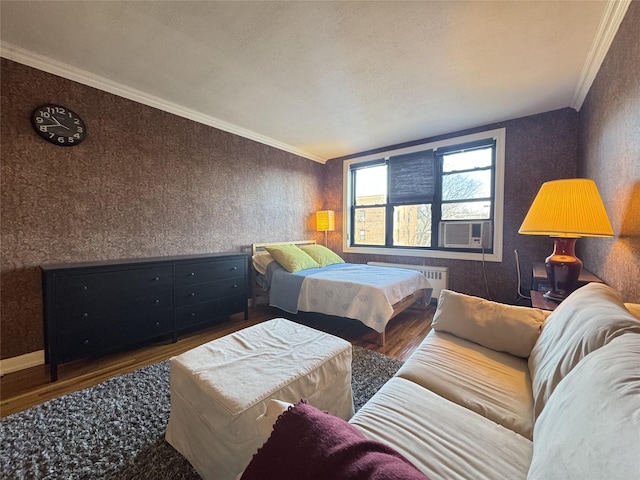 bedroom with crown molding, radiator, and dark wood-type flooring