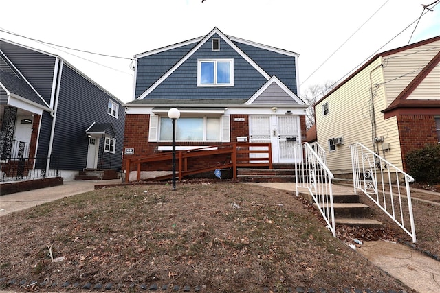 view of front of house with entry steps and brick siding